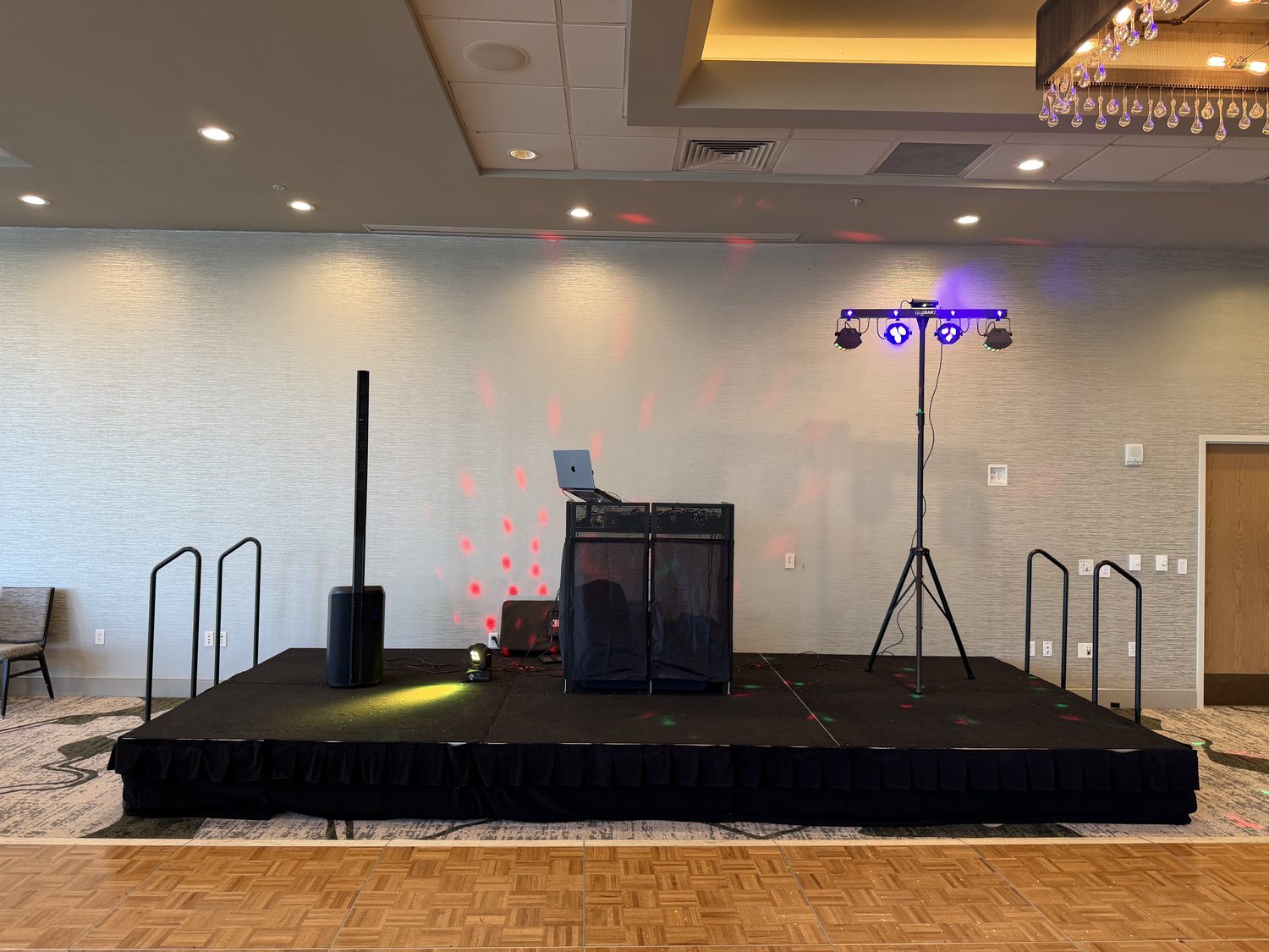 Full DJ stage setup with lighting at a prom